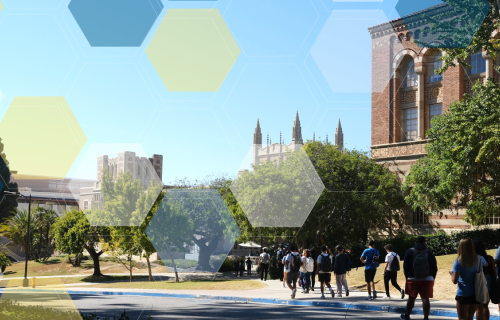 Students walking past gothic brick buildings partially obscured by green trees.